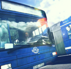 Close-up of the front of a blue colored bus. Photo.